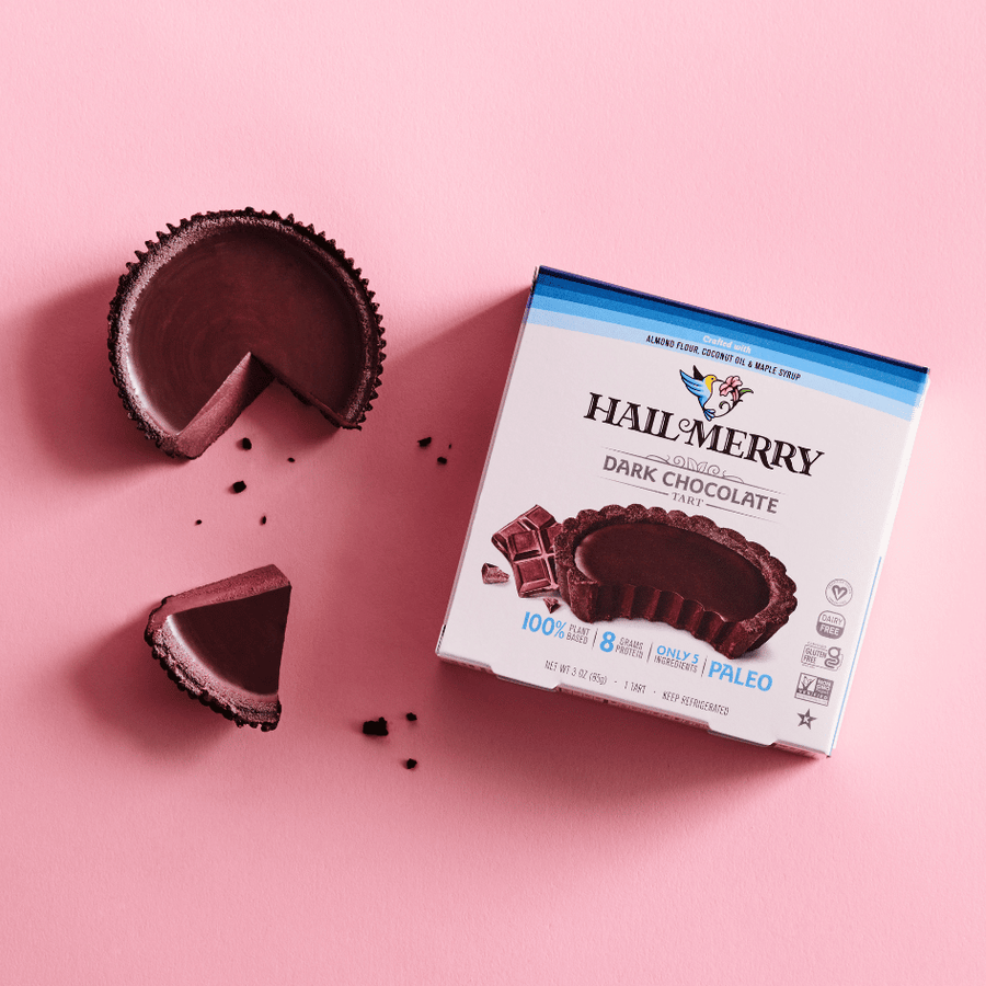 Box of Hail Merry No Bake Dark Chocolate Tarts besides a mini dark chocolate tart. Vegan. Dairy Free. Buy Online. Gluten Free. 